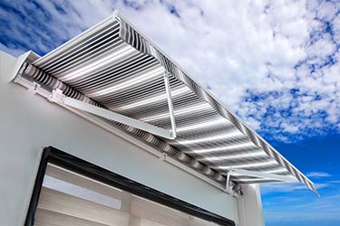 Contemporary, state of the art, retractable patio awning on trendy building