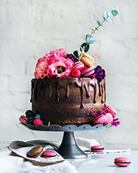 Chocolate wedding cake with flowers and macarons