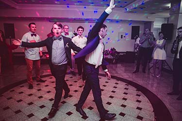 Wedding guests dancing and having fun to DJ music
