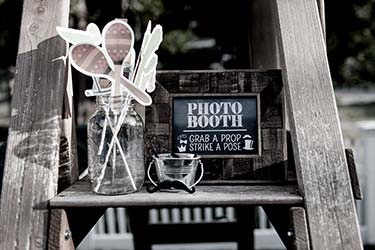 Charming, eclectic mobile photobooth setup at wedding with props