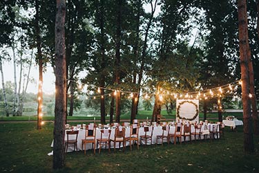 Evening, outdoor, festive gathering at banquet table
