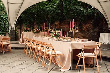 Simple and elegant Mediterranean style table setting under marquee