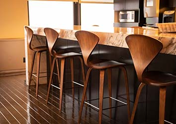 Bespoke wooden bench chairs in elegant kitchen