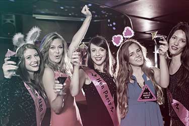 Five women celebrating at a bachelorette party in a dance club