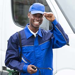 Smiling pest control technician in uniform