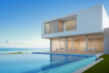 Modern minimalist beach side home with tiled infinity pool, overlooking the ocean