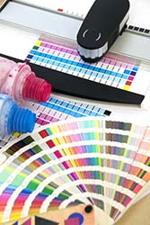 Printing supplies and Pantone swatchbook in preparation for large print job