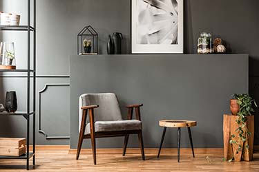 Vintage chair upholstered in stunning grey velvet material, sitting in modern, stylish lounge