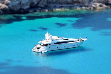 Luxury yacht parked on a tropical coast with clear blue water
