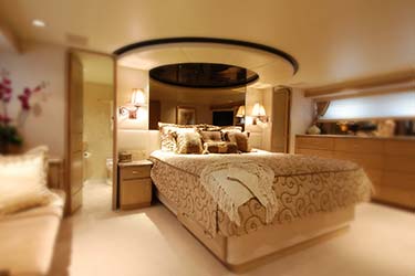 Interior shot of master bedroom cabin with ensuite on luxury yacht